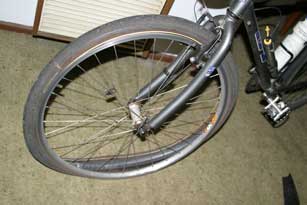 Riding through smashed bottle remains is not a good idea